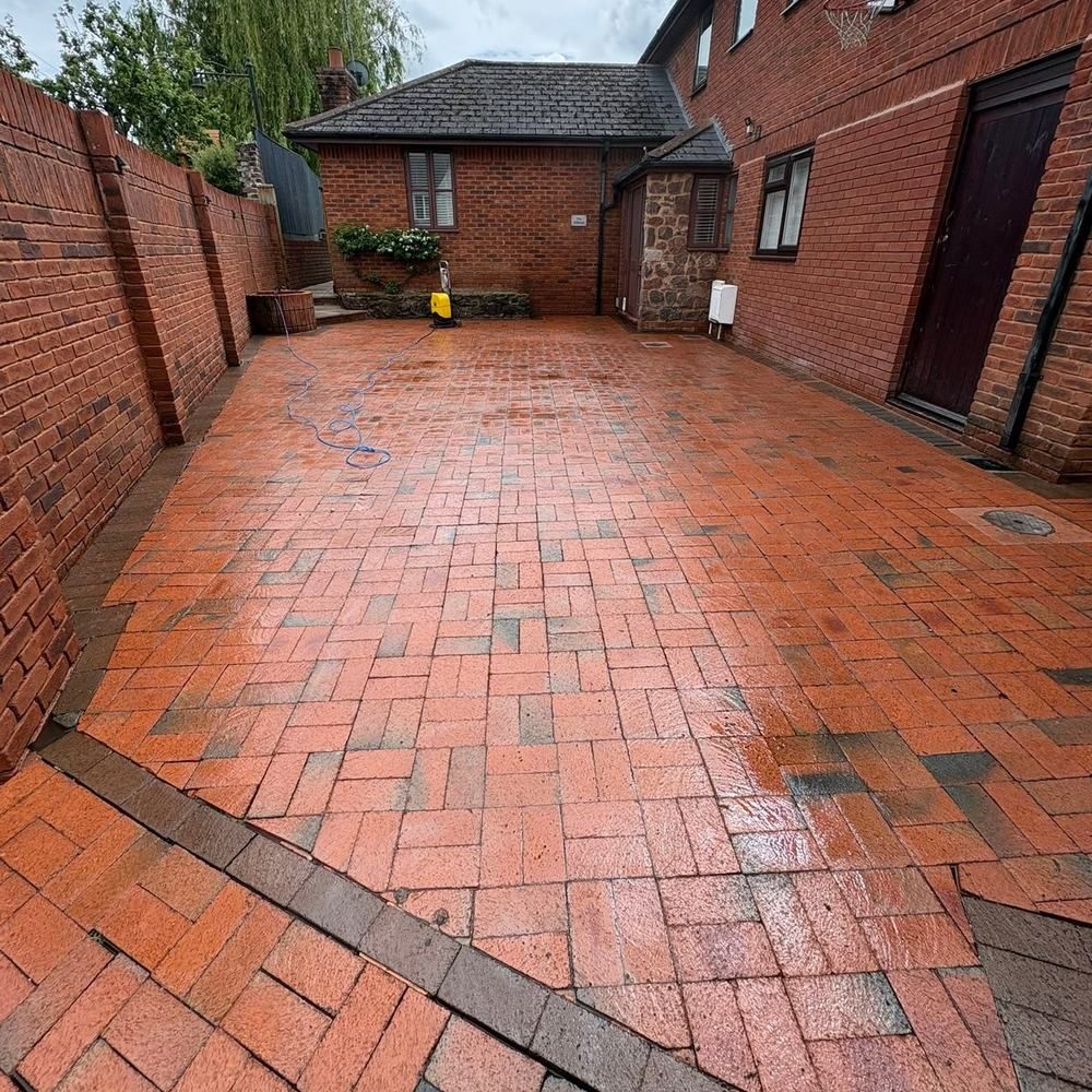 Brick paved courtyard driveway after cleaning by Owens Exterior Cleaning, Devon