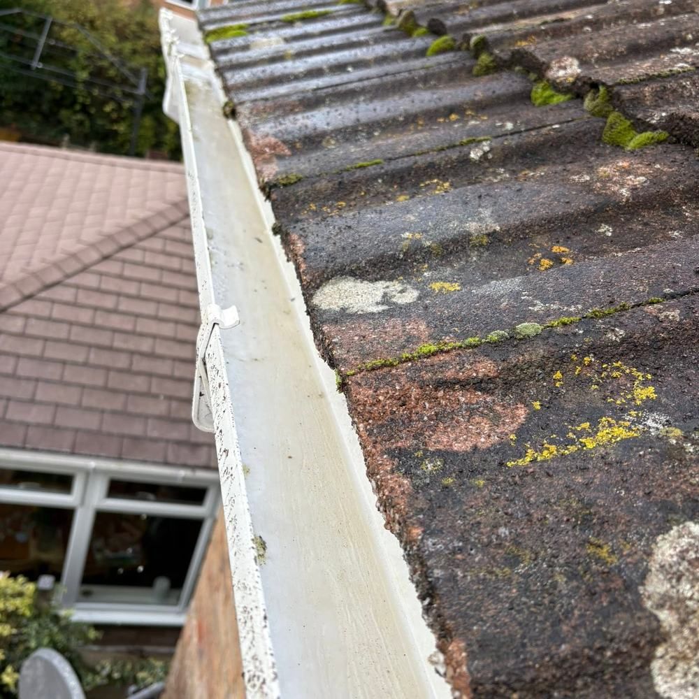 Gutter below a roof valley after cleaning by Owens Exterior Cleaning, Devon