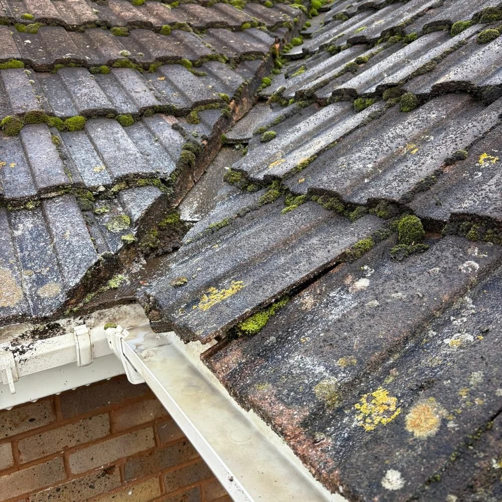 Gutter below a roof valley before cleaning by Owens Exterior Cleaning, Devon
