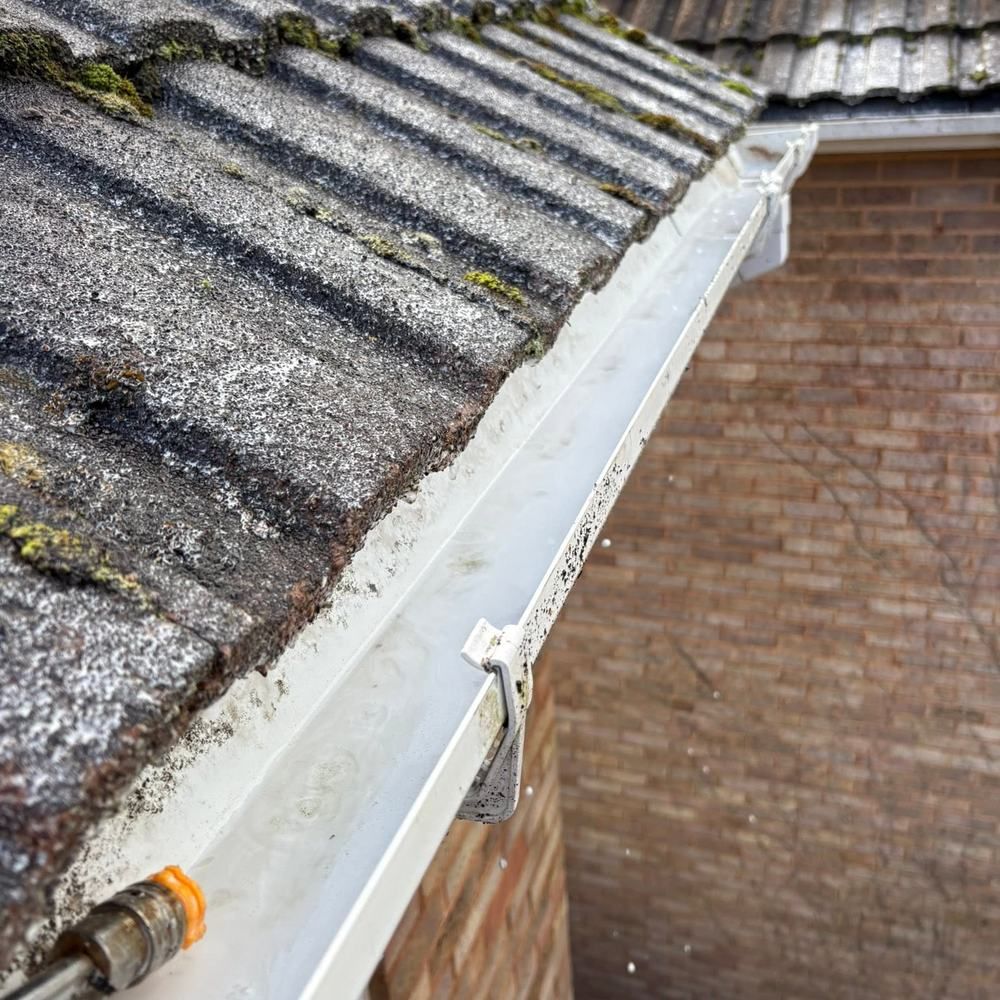 Gutter with moss and debris after cleaning by Owens Exterior Cleaning, Devon
