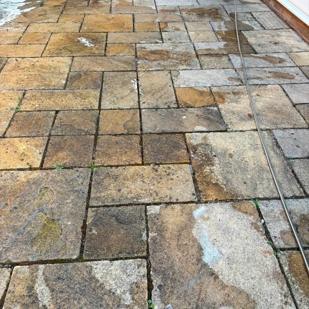 Buff sandstone patio before cleaning by Owens Exterior Cleaning, Devon
