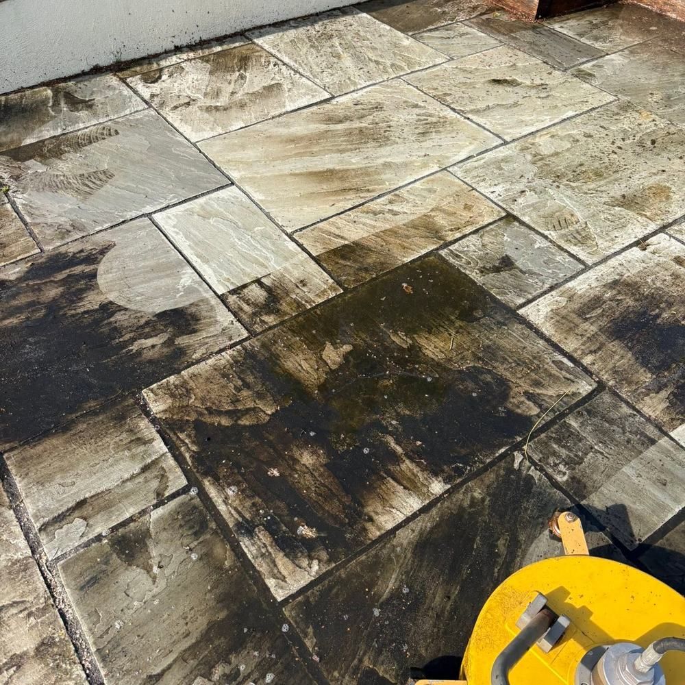 Grey sandstone patio before cleaning by Owens Exterior Cleaning, Devon