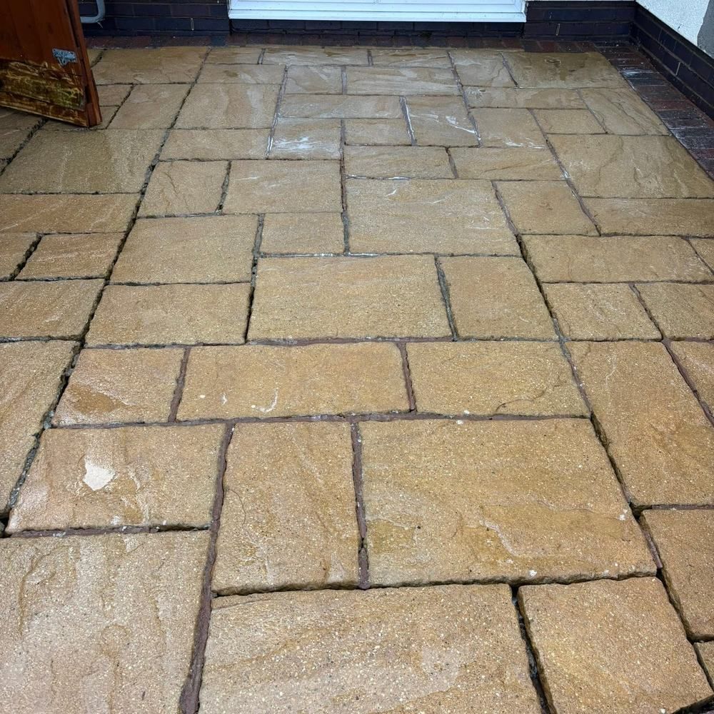 Random pattern sandstone patio after cleaning by Owens Exterior Cleaning, Devon