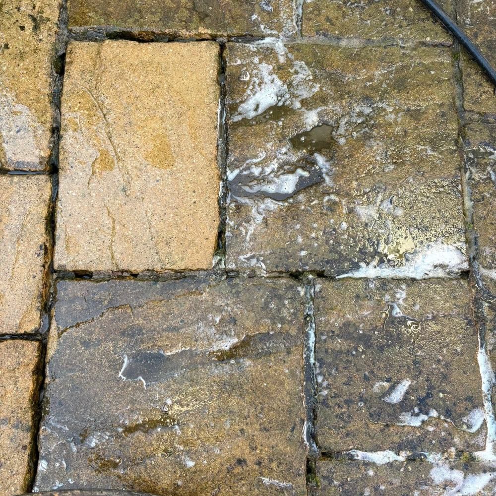 Random pattern sandstone patio before cleaning by Owens Exterior Cleaning, Devon