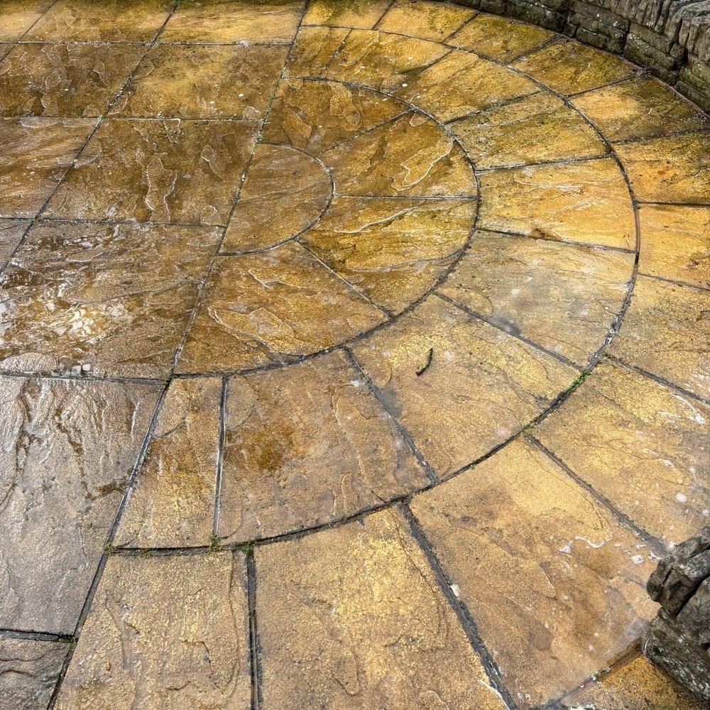 Sandstone circle patio before cleaning by Owens Exterior Cleaning, Devon