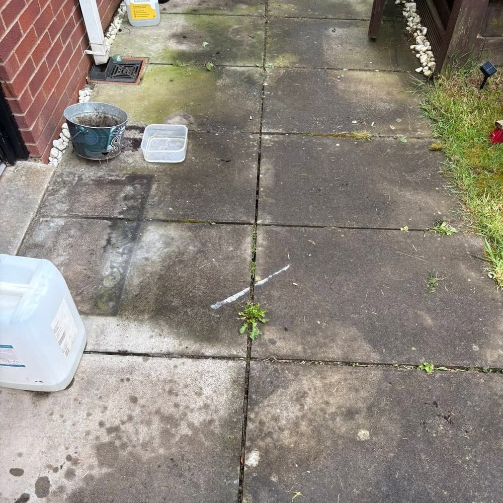 Concrete slab patio before cleaning by Owens Exterior Cleaning, Devon