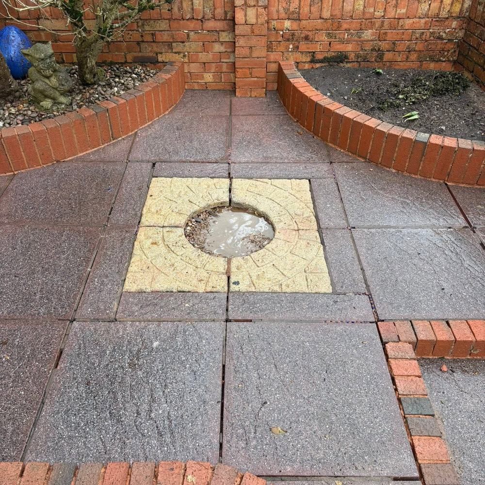 Patio with brick borders after cleaning by Owens Exterior Cleaning, Devon